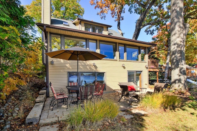 W5553 Oak Park Rd, Elkhorn, WI 53121 - back of house with a patio and a sunroom