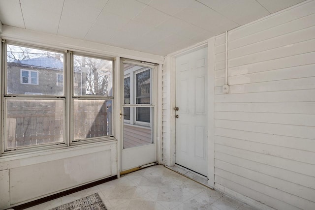 doorway with wood walls