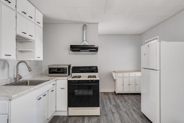 kitchen featuring range with gas stovetop, light hardwood / wood-style floors, white fridge, sink, and white cabinetry