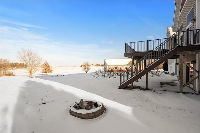 snowy yard with an outdoor fire pit