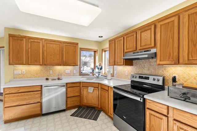 kitchen featuring sink, backsplash, and appliances with stainless steel finishes