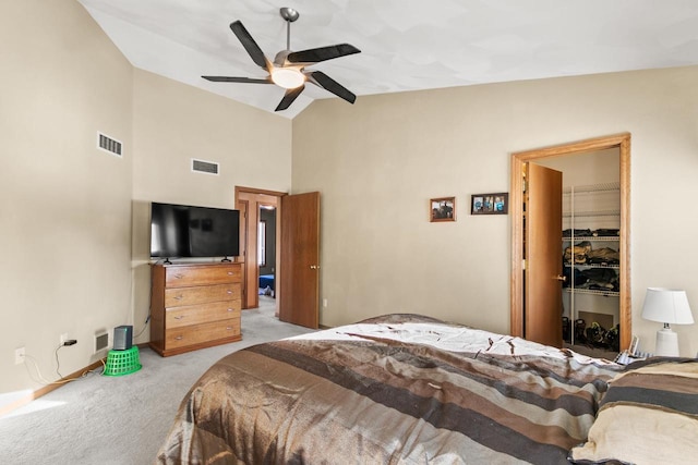 bedroom with light colored carpet, a closet, ceiling fan, a spacious closet, and high vaulted ceiling