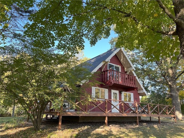 back of property featuring a balcony