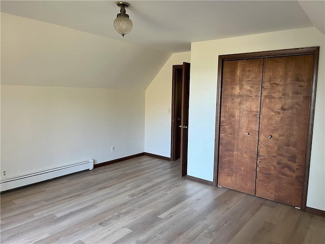 bonus room featuring lofted ceiling, light hardwood / wood-style floors, and baseboard heating