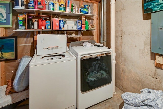 clothes washing area with washing machine and dryer and electric panel