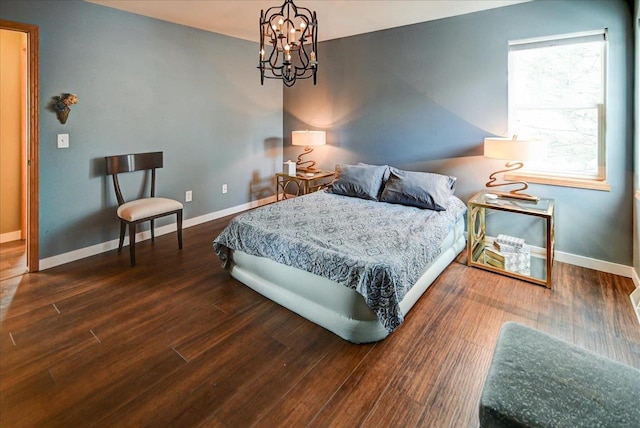 bedroom featuring dark hardwood / wood-style flooring and a notable chandelier