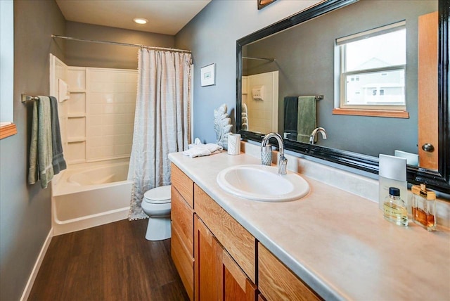 full bathroom with hardwood / wood-style floors, shower / bathtub combination with curtain, vanity, and toilet