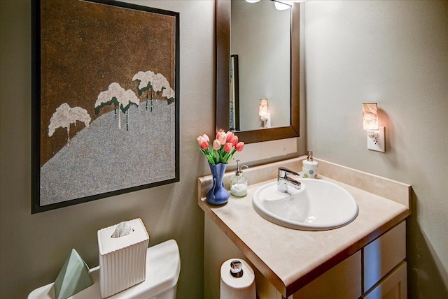 bathroom featuring toilet and vanity