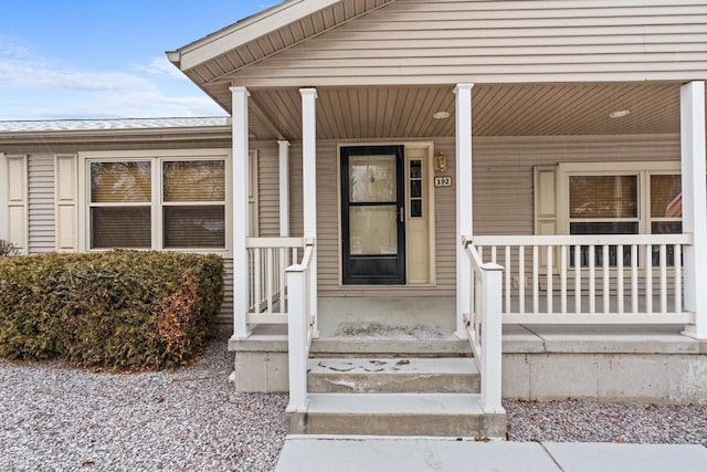 doorway to property featuring covered porch