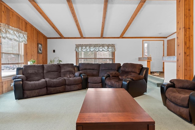 carpeted living room featuring beamed ceiling and wooden walls