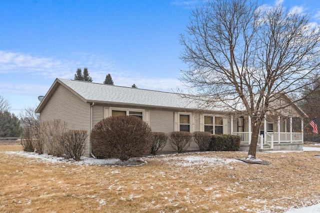 view of snow covered exterior featuring covered porch