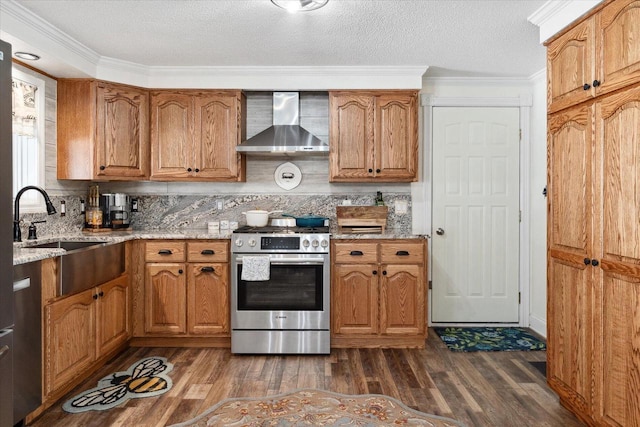 kitchen with stainless steel appliances, light stone counters, wall chimney exhaust hood, and dark wood-style flooring