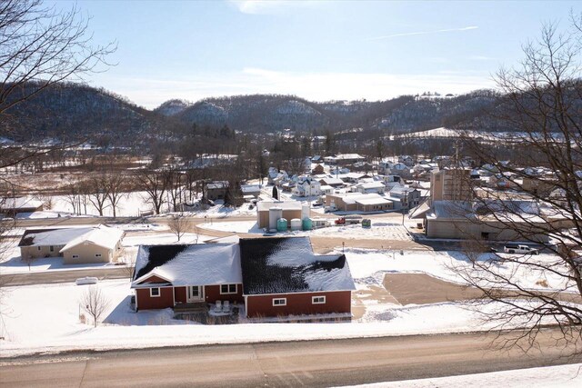 snowy aerial view featuring a mountain view