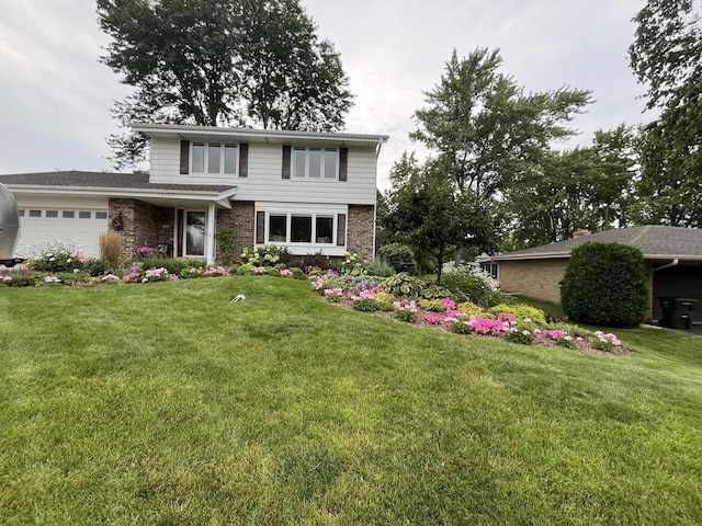 view of front facade featuring a front yard and a garage