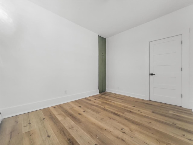 spare room with light hardwood / wood-style flooring