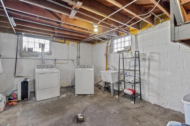 basement featuring sink and washer and dryer