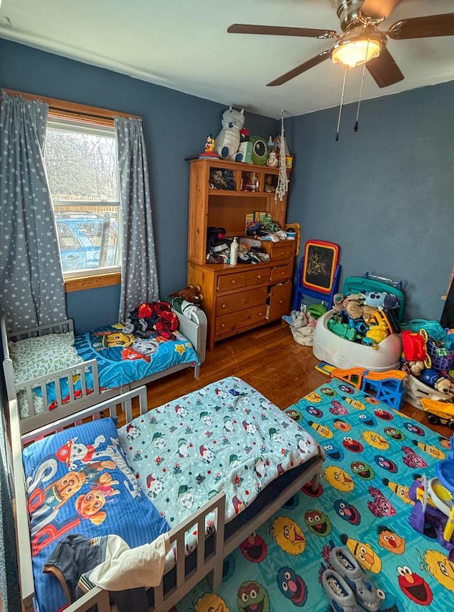 bedroom with hardwood / wood-style floors and ceiling fan