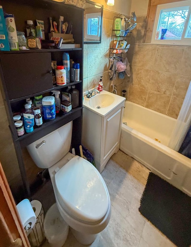 full bathroom featuring toilet, tile walls, shower / bath combo, backsplash, and vanity