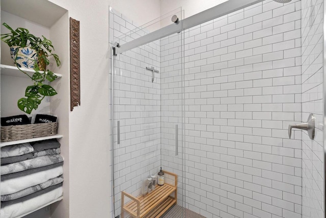 bathroom with a shower with door