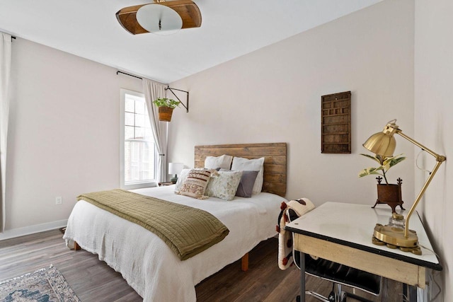 bedroom with dark hardwood / wood-style flooring