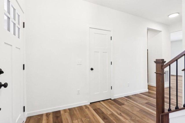 hall with wood-type flooring