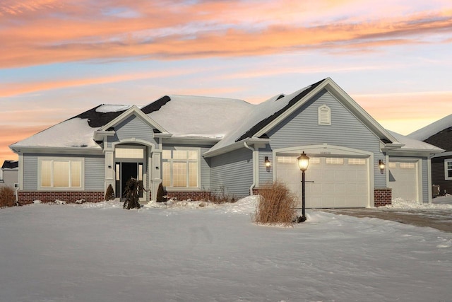 ranch-style house featuring a garage and brick siding