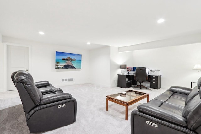 living area featuring recessed lighting, visible vents, and light carpet