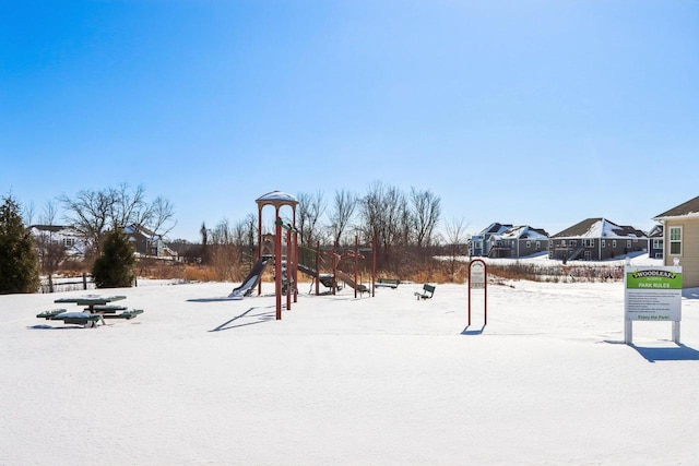 snowy yard featuring playground community