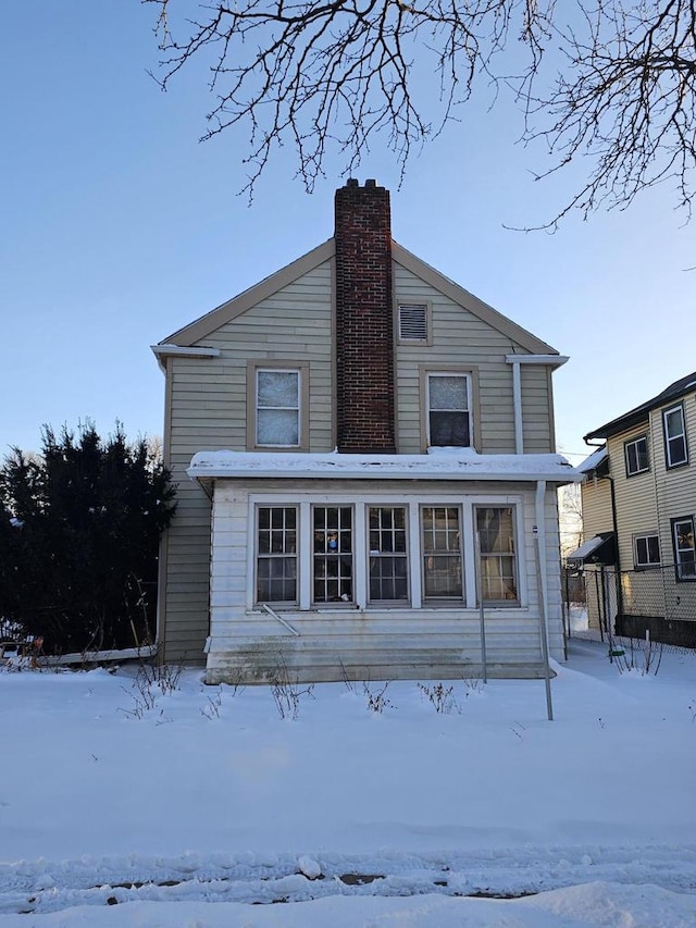 view of snow covered rear of property