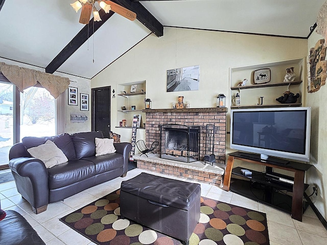 tiled living room with ceiling fan, lofted ceiling with beams, a brick fireplace, and built in shelves