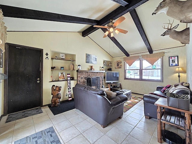 tiled living room featuring a brick fireplace, ceiling fan, and vaulted ceiling with beams