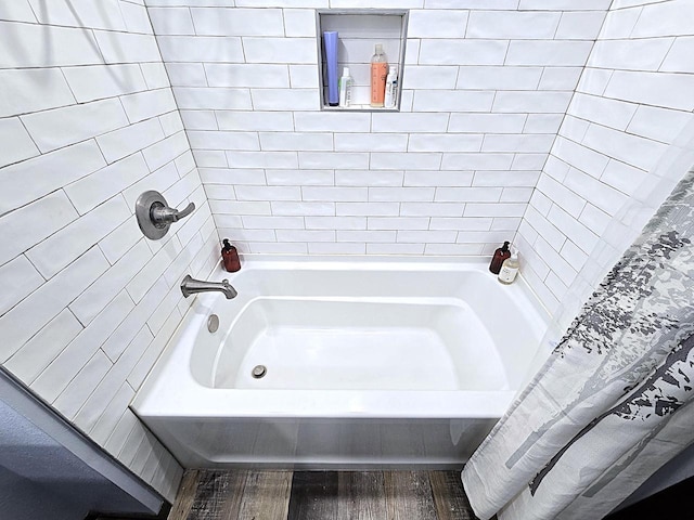 bathroom with shower / bath combination with curtain and wood-type flooring