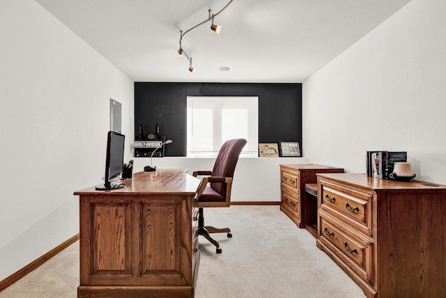 office space with light colored carpet and track lighting