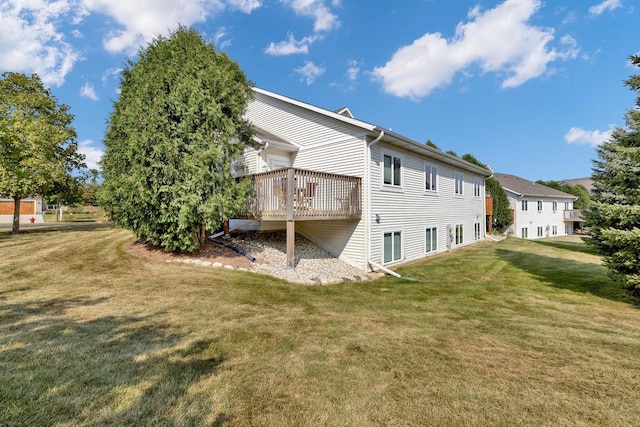 back of property featuring a yard and a deck