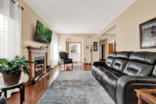 living room with hardwood / wood-style floors and a tile fireplace