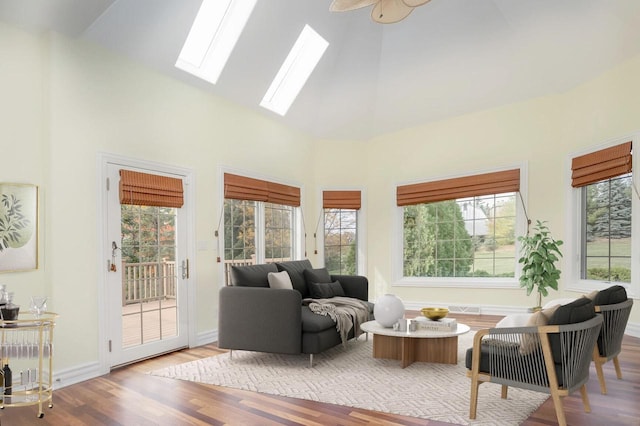 living room featuring wood finished floors, high vaulted ceiling, and a wealth of natural light