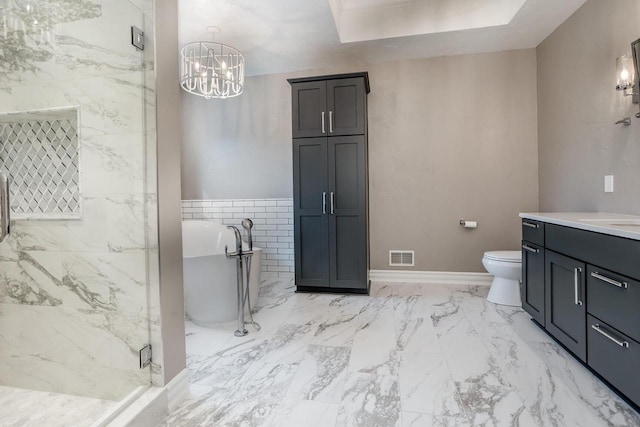 full bathroom with marble finish floor, visible vents, a marble finish shower, vanity, and a freestanding tub