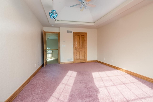 spare room with carpet, visible vents, and baseboards