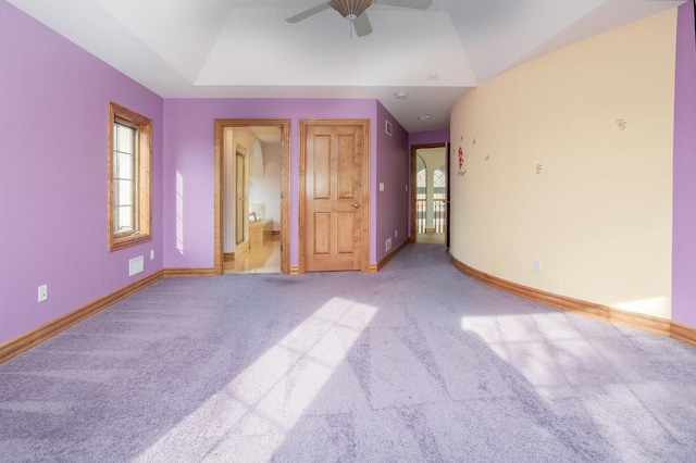 unfurnished bedroom featuring ceiling fan, light colored carpet, and baseboards