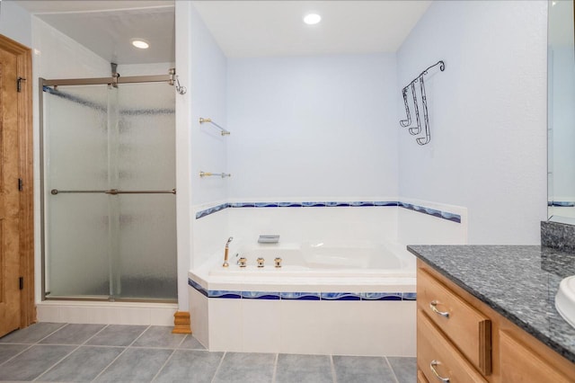 full bathroom with tile patterned floors, a shower stall, a garden tub, and vanity