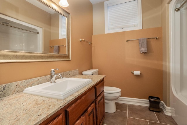 full bathroom featuring baseboards, toilet, tile patterned floors, vanity, and a shower