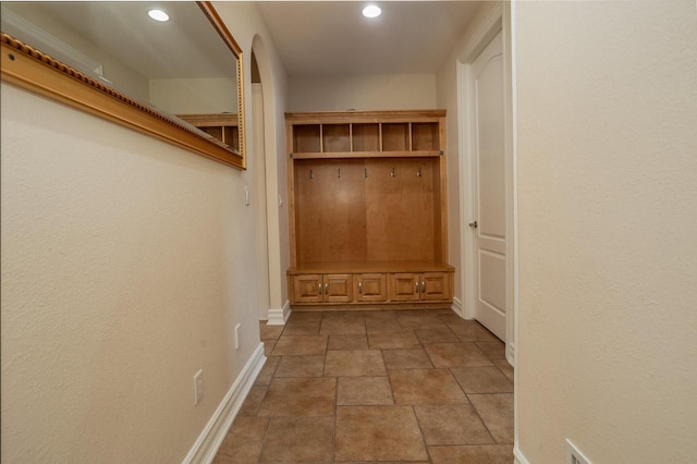 mudroom featuring recessed lighting, stone finish flooring, and baseboards