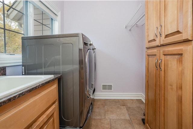 laundry area with cabinet space, baseboards, and visible vents