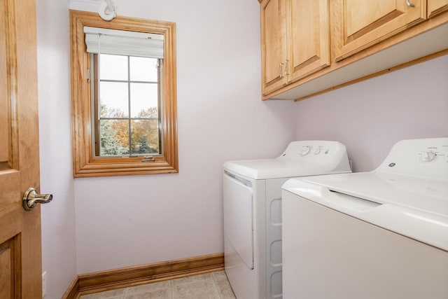 laundry area featuring cabinet space, washing machine and dryer, baseboards, and light tile patterned floors