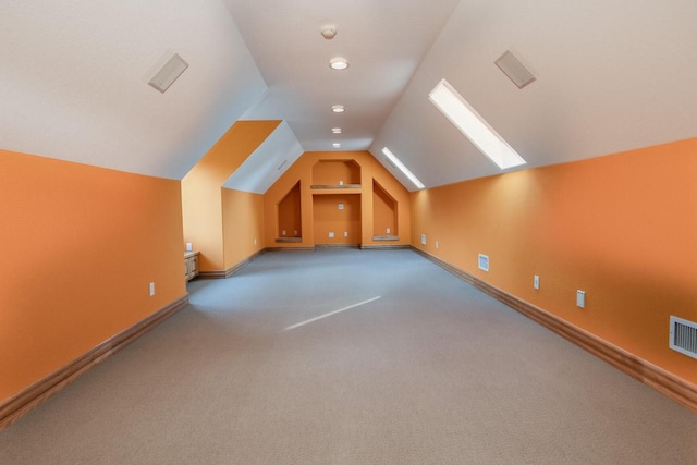 additional living space with carpet, vaulted ceiling, and baseboards