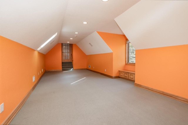 bonus room with lofted ceiling, recessed lighting, light carpet, and baseboards