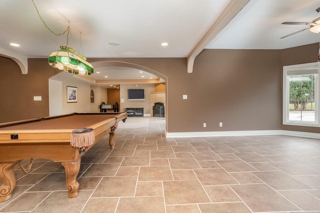 playroom with baseboards, a ceiling fan, and arched walkways