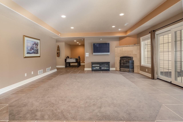 unfurnished living room featuring recessed lighting, a fireplace, light carpet, and visible vents