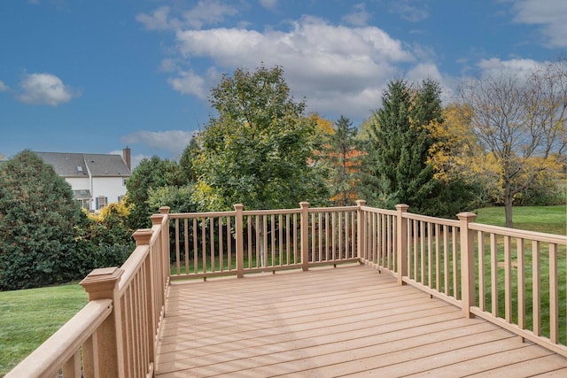 wooden deck featuring a yard