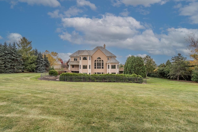 exterior space with a front yard, a chimney, and fence